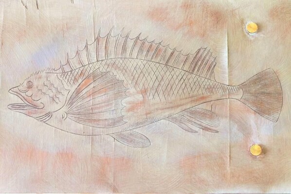 A wooden panel with a fish carving. - Hostal Rom (Roses)