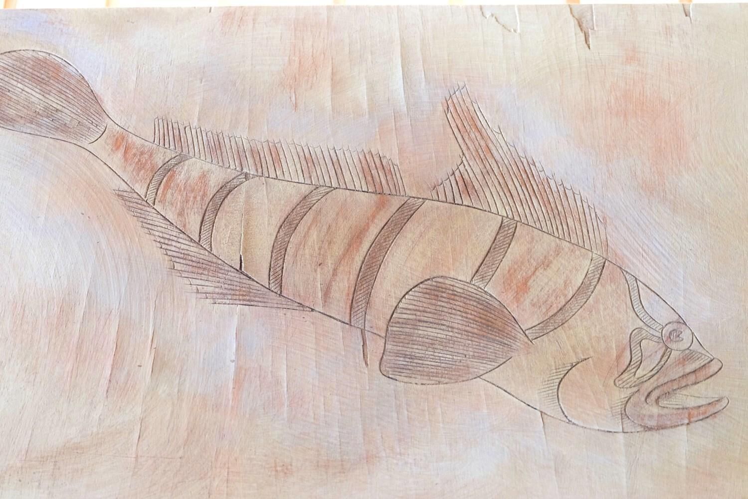 A detailed drawing of a fish with stripes and fins.