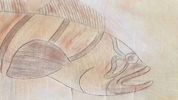 A close-up of a wooden surface with a carved design, possibly a piece of furniture or a decorative panel.