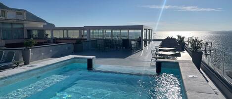 Seasonal outdoor pool, open 10:30 AM to 6:00 PM, pool umbrellas