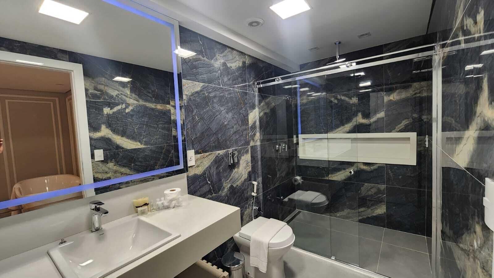 luxury studio suite | bathroom | shower, rainfall showerhead, free toiletries, hair dryer