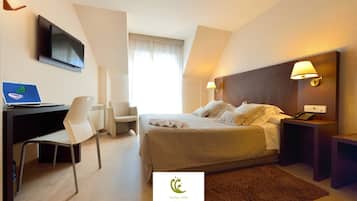 Een hotelkamer met een bed, bureau, stoel en een televisie.