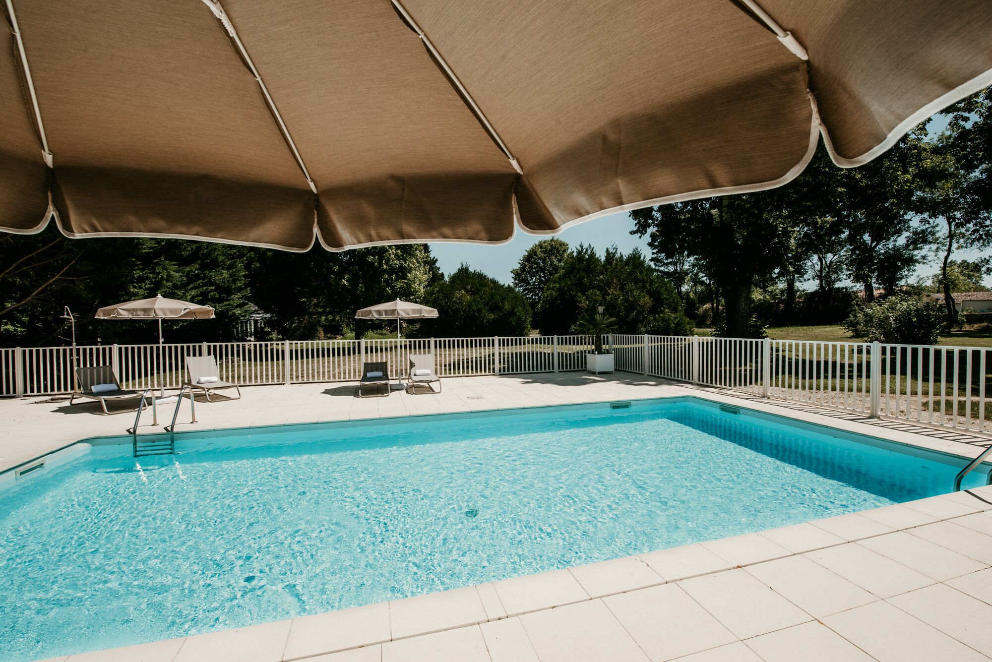 seasonal outdoor pool, open 8:00 am to 8:00 pm, pool umbrellas