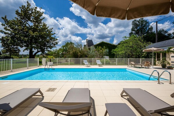 Seasonal outdoor pool, open 8:00 AM to 8:00 PM, pool umbrellas
