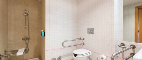 A bathroom with a shower, toilet, and grab bars.