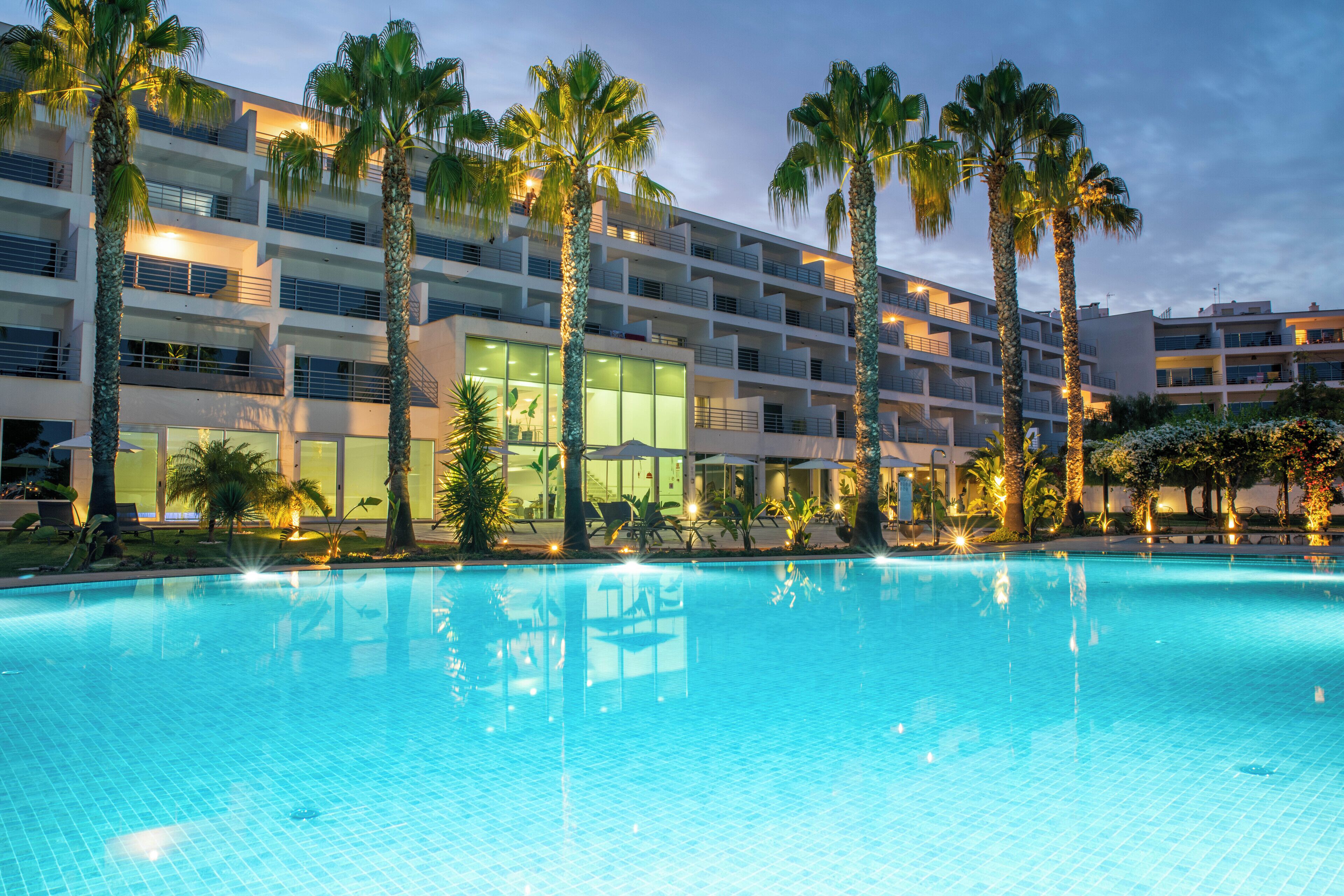 Seasonal outdoor pool, open 8:00 AM to 8:00 PM, pool umbrellas