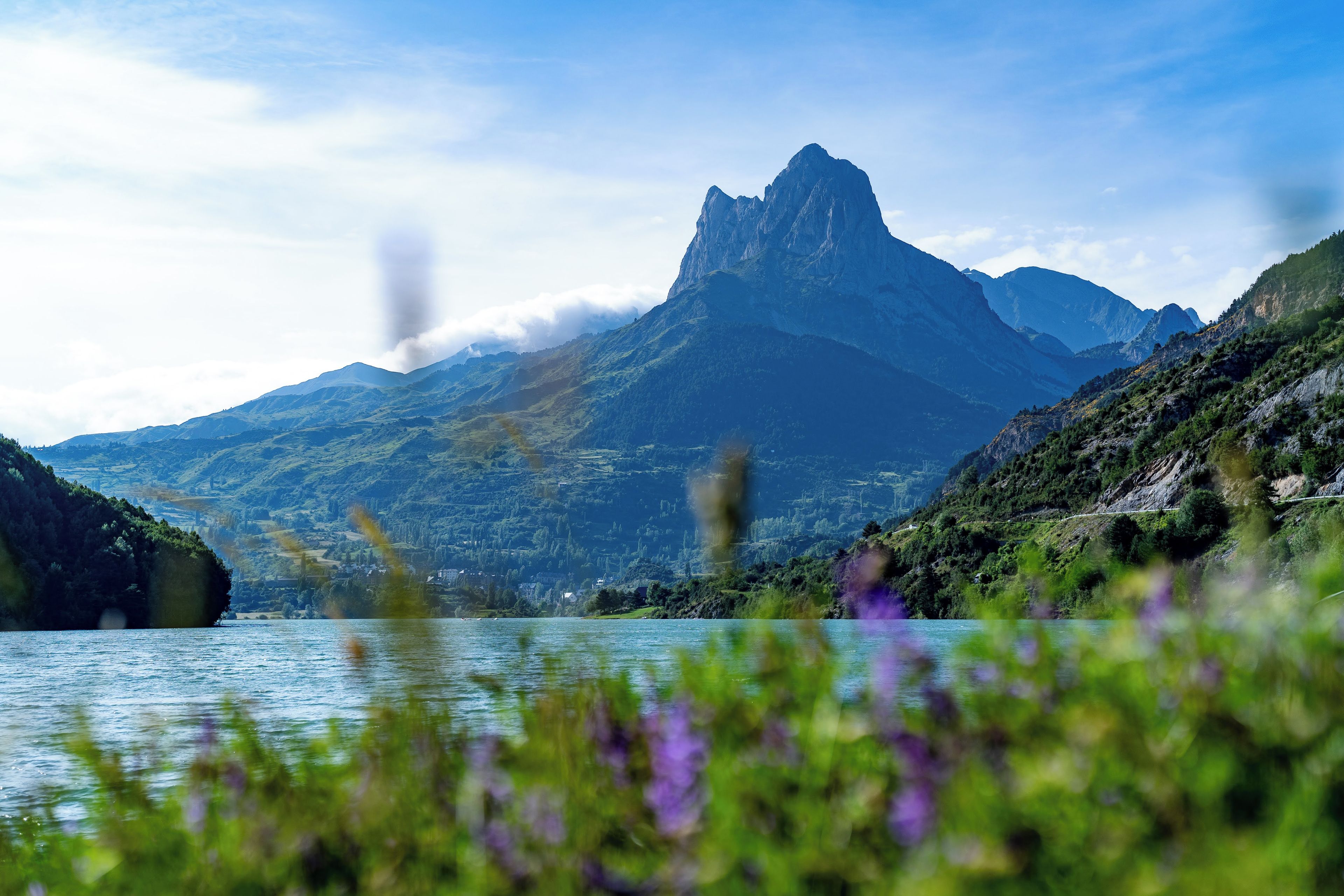 A mountainous landscape with a lake and a prominent peak.
