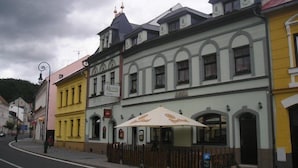 A row of colorful buildings with a sign for a hotel.