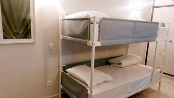 A bunk bed with a headboard, a pillow, and a blanket.