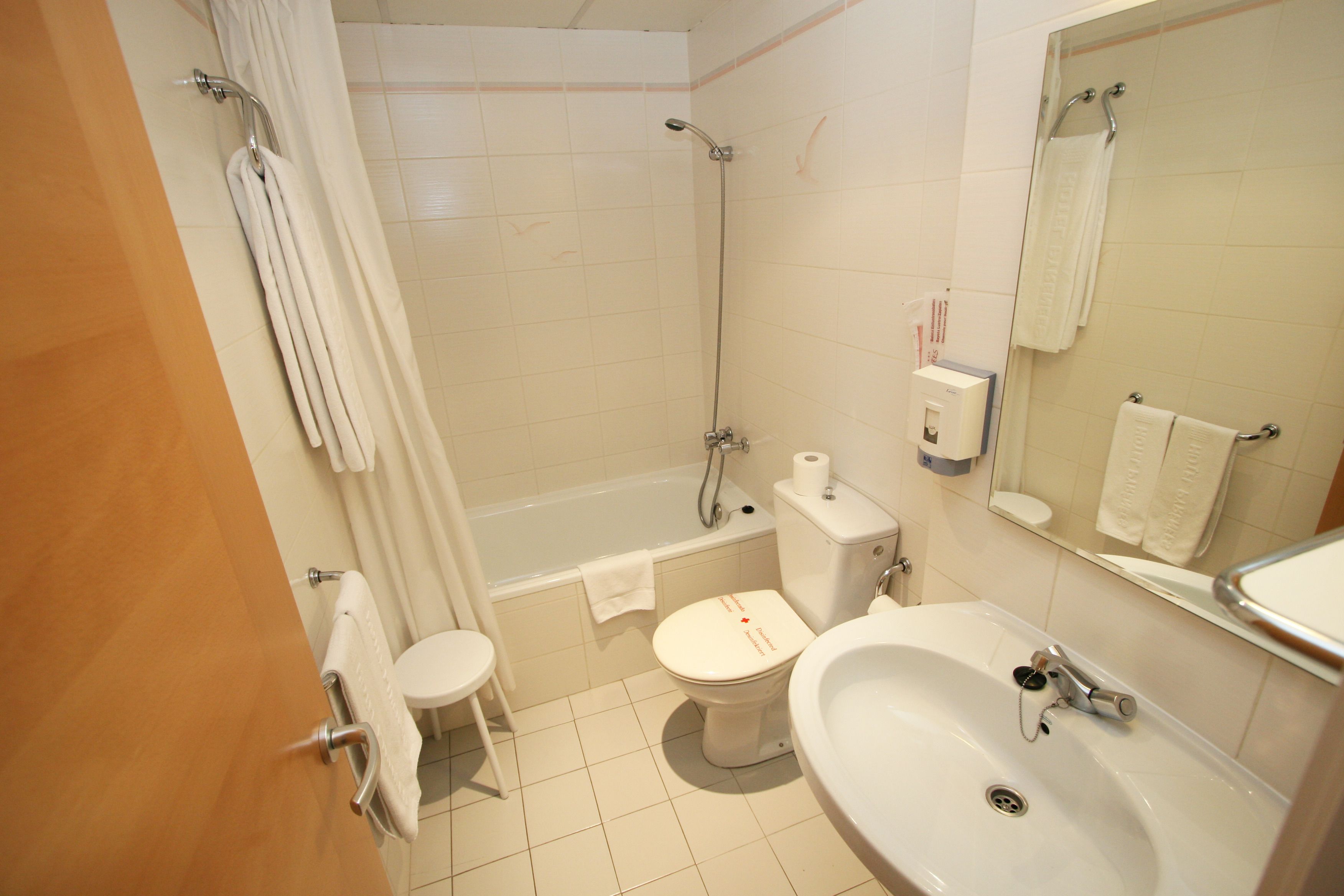 A bathroom with a bathtub, toilet, sink, and a shower.