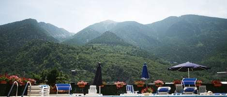 Seasonal outdoor pool, open 9:00 AM to 7:30 PM, pool umbrellas