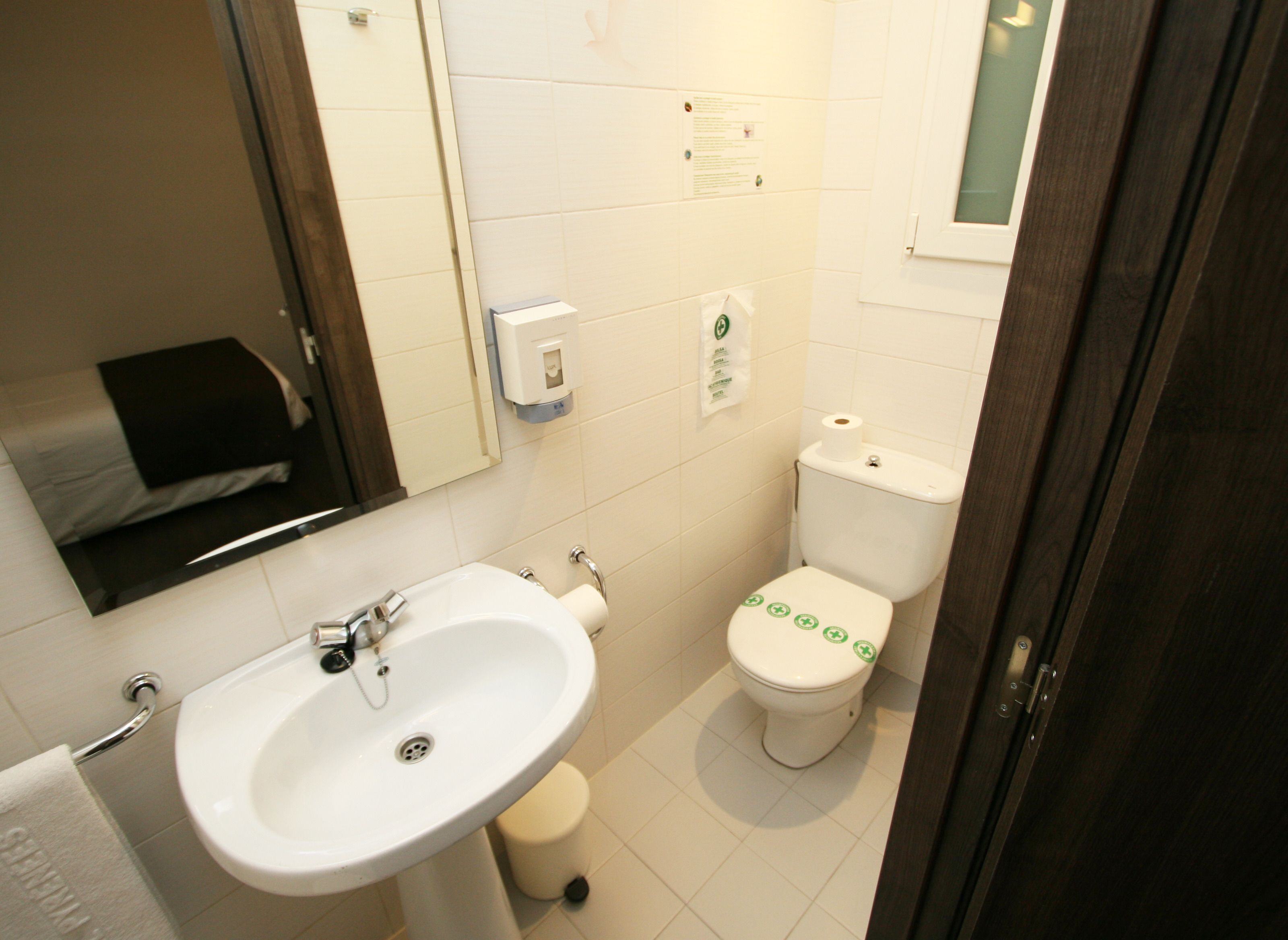 Un baño pequeño con lavamanos, inodoro y espejo.