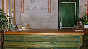 A hotel reception desk with a sign reading "HOTEL ATHENOPOLIS" above it. - Athénopolis (Grimaud)