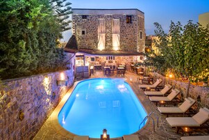 Una piscina al aire libre, sombrillas