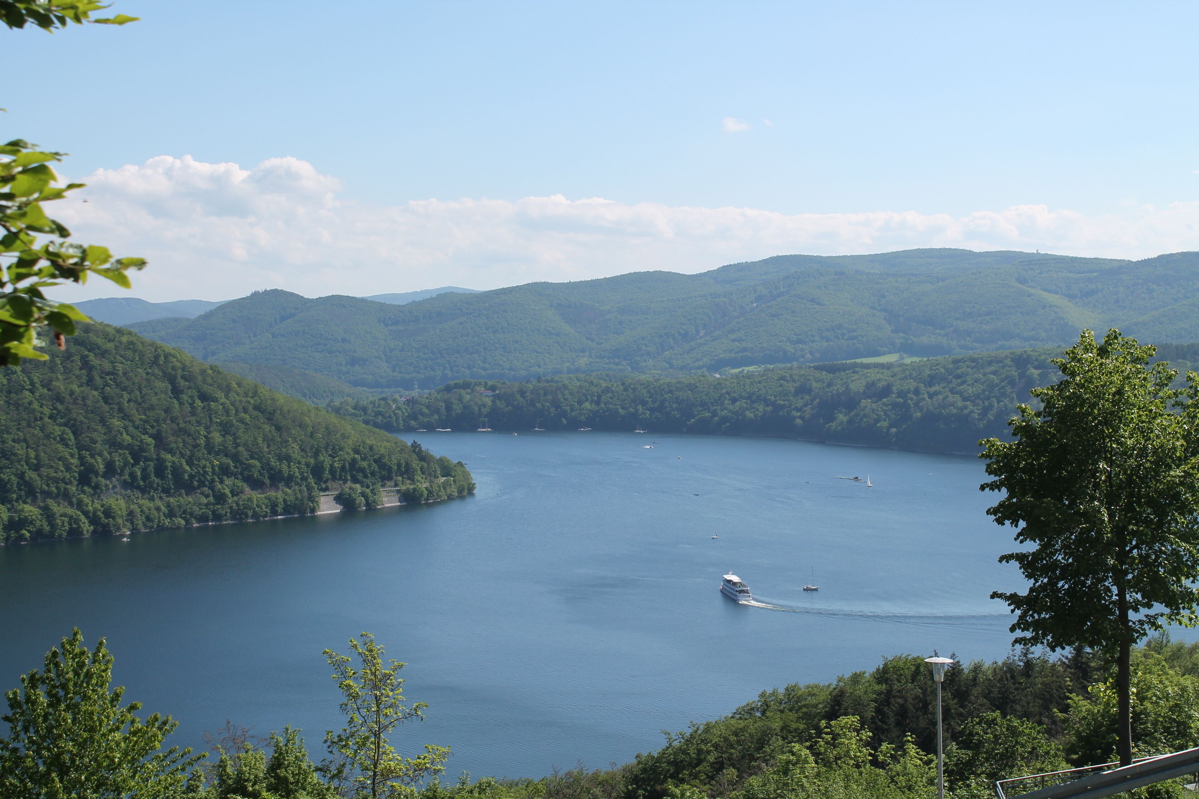 A lake surrounded by forested hills.