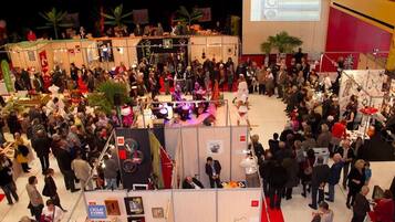 Un événement en intérieur très fréquenté, avec de nombreux stands et participants.