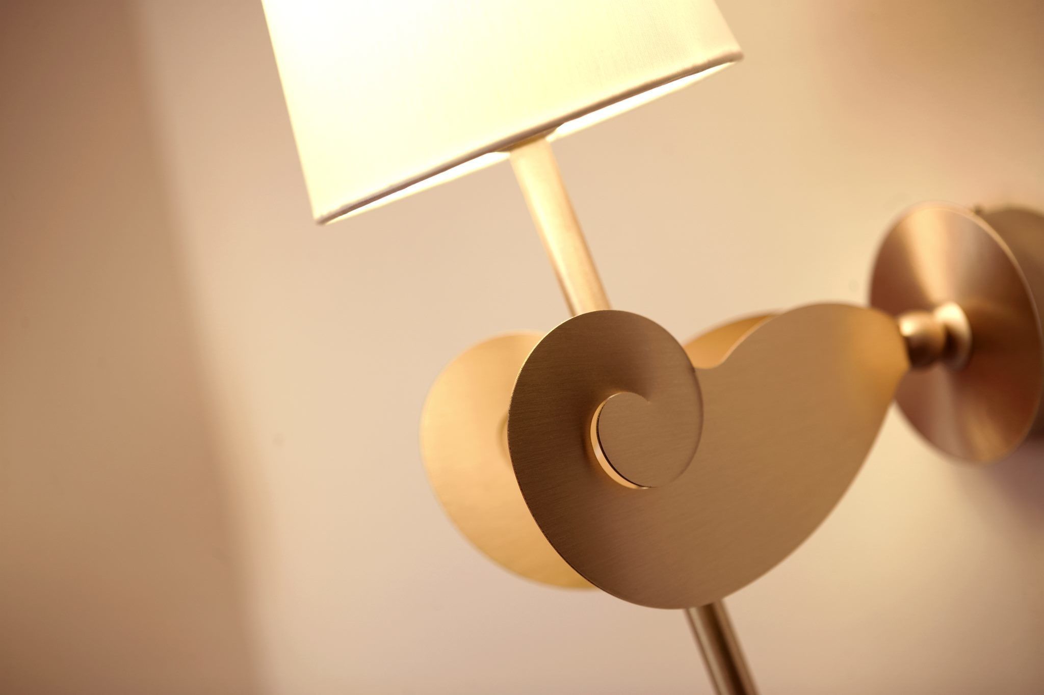 A wall-mounted lamp with a heart-shaped base and a rectangular shade.