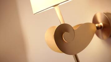 A wall-mounted lamp with a heart-shaped base and a rectangular shade.