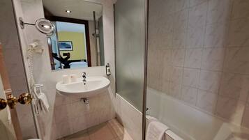 Ein Badezimmer mit Waschbecken, Spiegel, Toilette und Dusche.