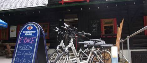 A wooden building with a signboard advertising a hotel and restaurant.