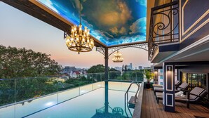 A rooftop pool with a city view, a glass balustrade, and a decorative ceiling. - Aira Boutique Hanoi Hotel & Spa (Hanoi)