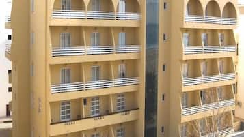 A multi-story building with balconies and windows.