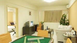 A compact hotel room with a pool table, a sofa, a small table with a plant, and a television. - Ane Hotel - Eying Branch (Chengdu)