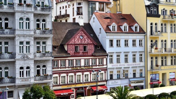 A historic building with multiple stories, featuring a mix of architectural styles including ornate facades and traditional windows. - Hotel Petr (Karlovy Vary)