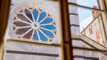 A large, ornate window with a circular design and a central pillar.