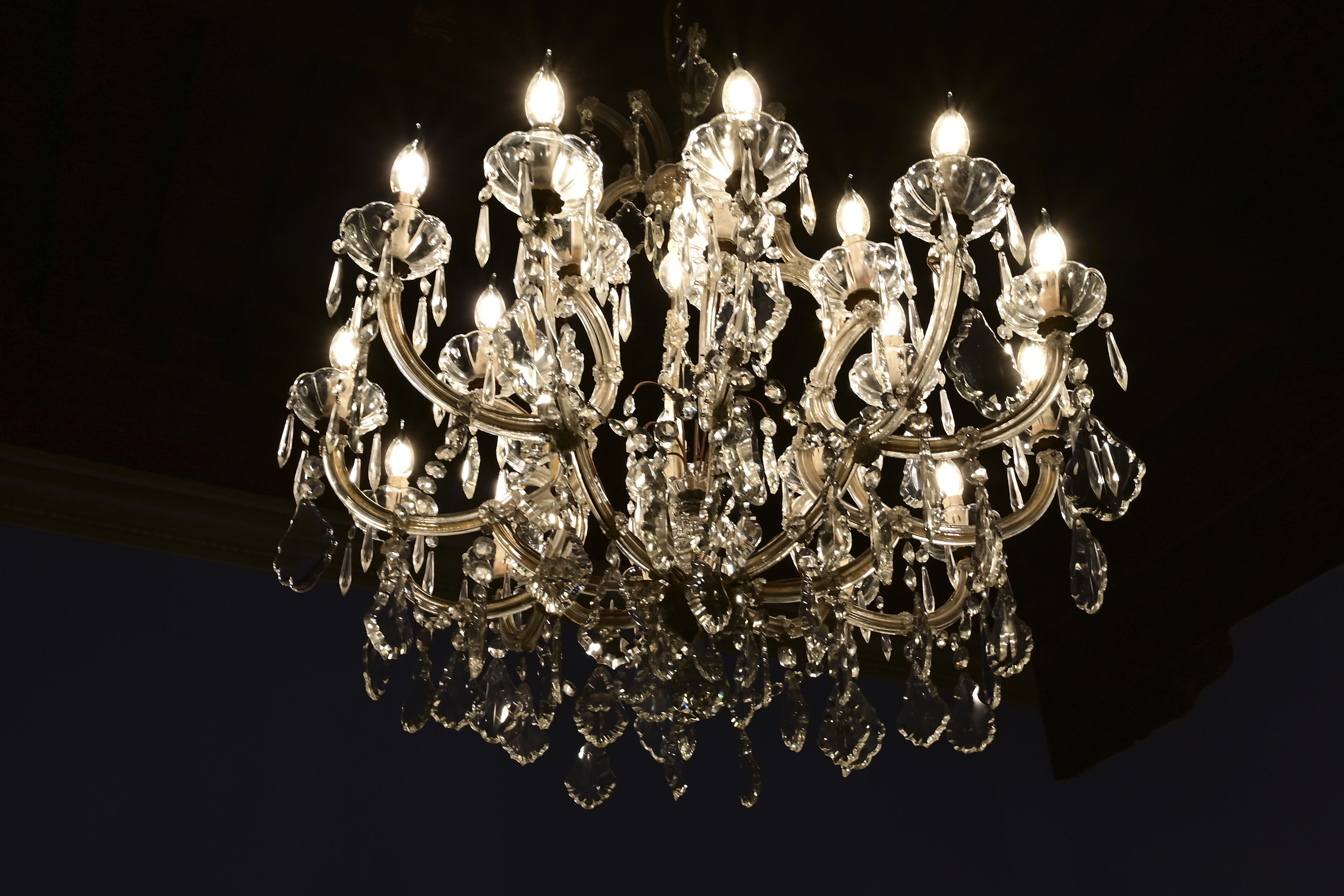 A chandelier with multiple arms and crystal decorations.