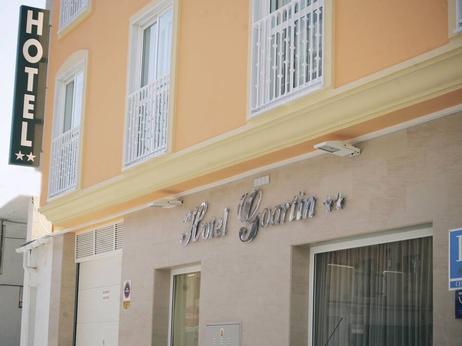 A hotel building with a sign reading "Hotel Goarin".