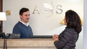 A reception desk with a telephone and a notepad.