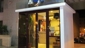 A building with a glass entrance and a sign above it. - AS São João da Madeira (Sao Joao da Madeira)
