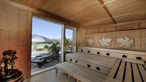 A wooden interior with a bench, a decorative wall, and a view of the outdoors. - Gartenhotel & Weingut Pfeffel Dürnstein (Durnstein)