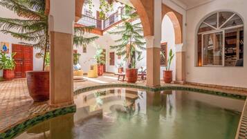 Indoor pool, open 10:00 AM to 10:00 PM, pool loungers
