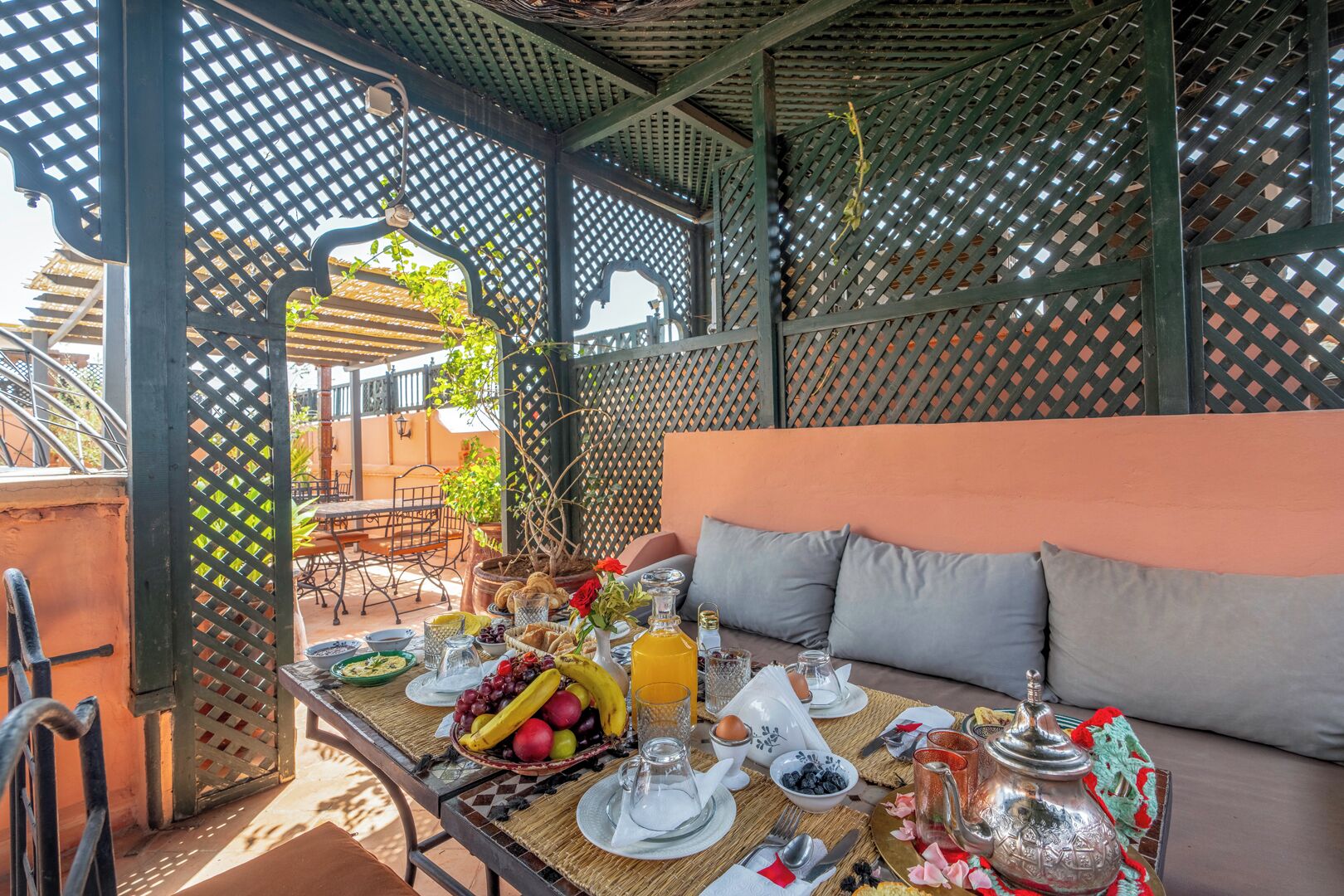 A breakfast setup with a table, seating, and a view of the outdoors.