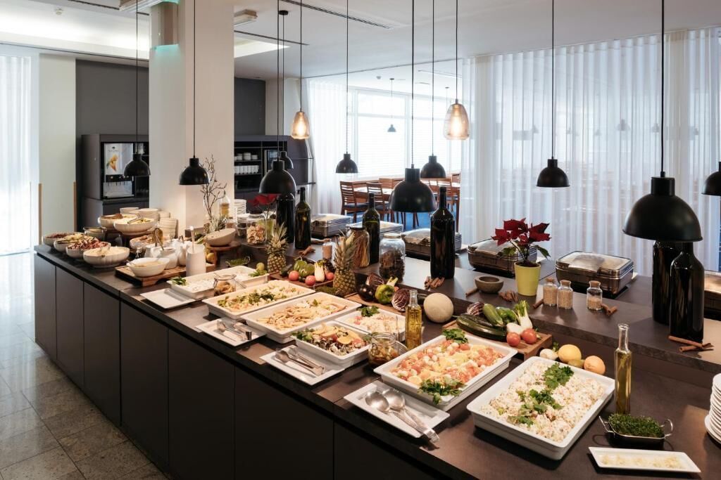 A buffet setup with various food items and condiments.