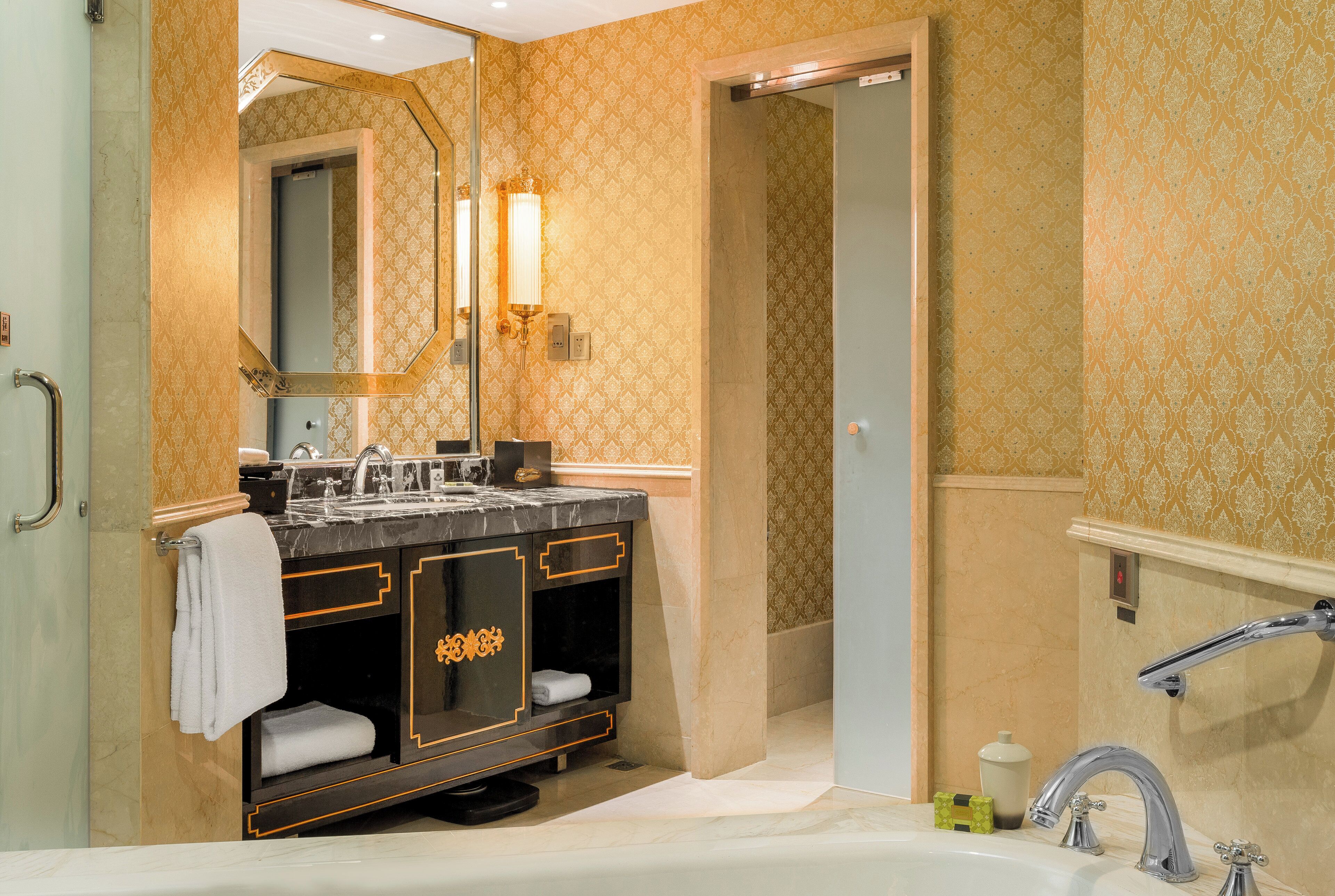 A bathroom with a double sink, a large mirror, and a bathtub.