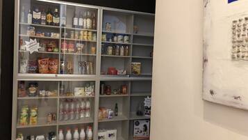 A multi-shelf display case with various food and drink items, including snacks, beverages, and condiments.