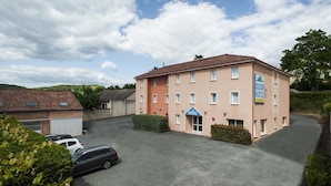 Un hôtel doté d’un toit plat, de nombreuses fenêtres et d’une enseigne indiquant qu’il s’agit d’un hôtel.