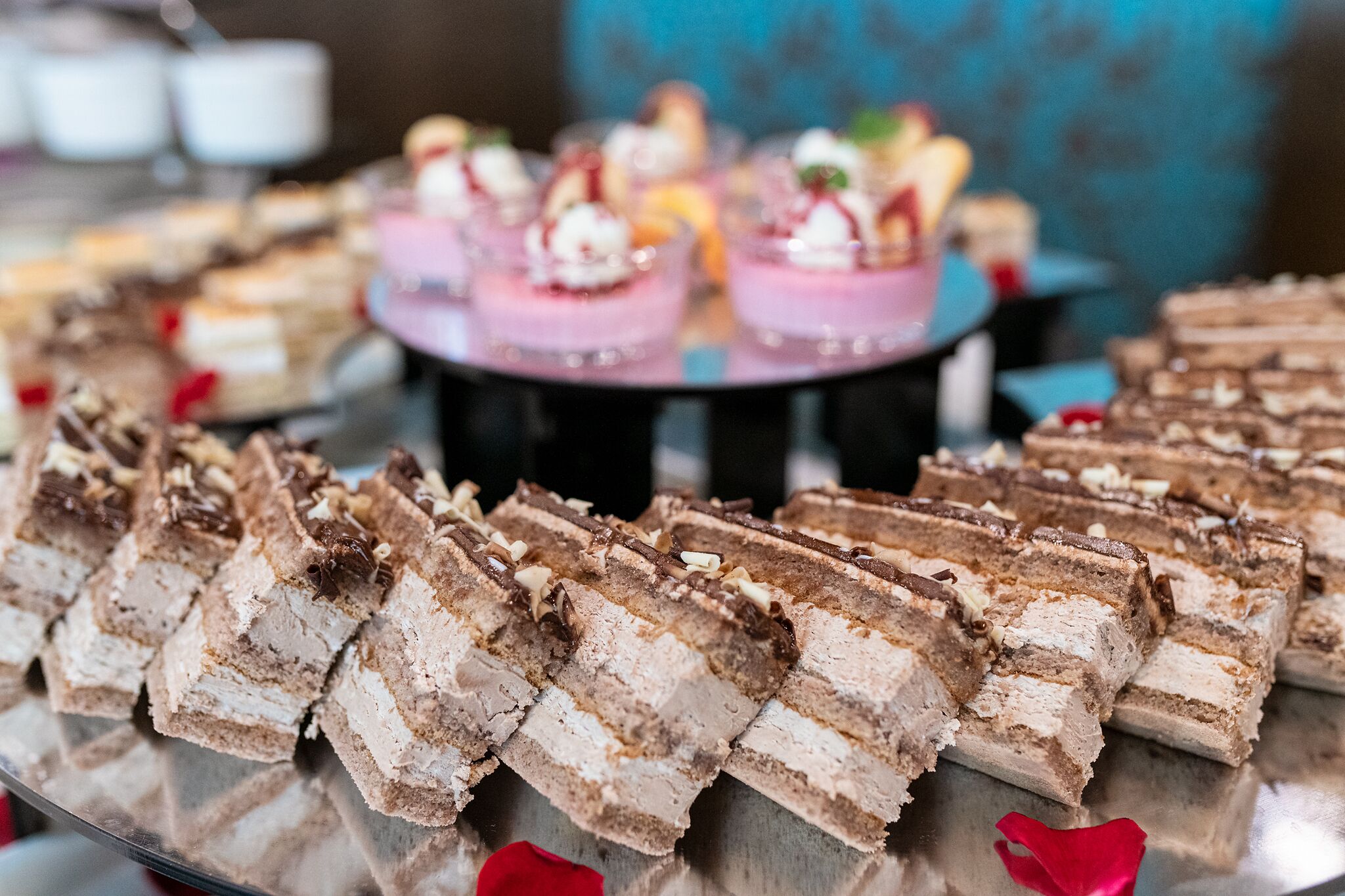 A dessert display with various cakes and pastries.