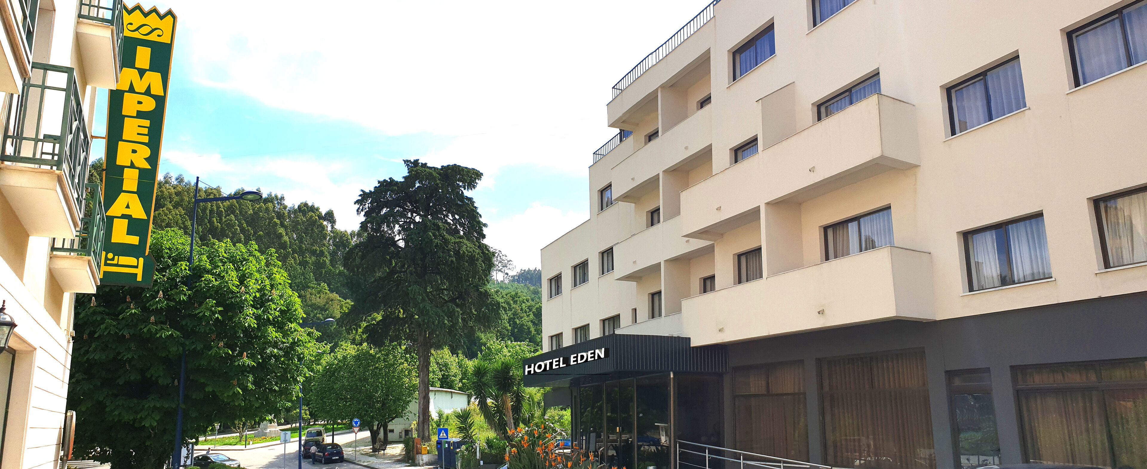 A hotel named 'Hotel Eden' with a modern facade, large windows, and a balcony on the upper floor.