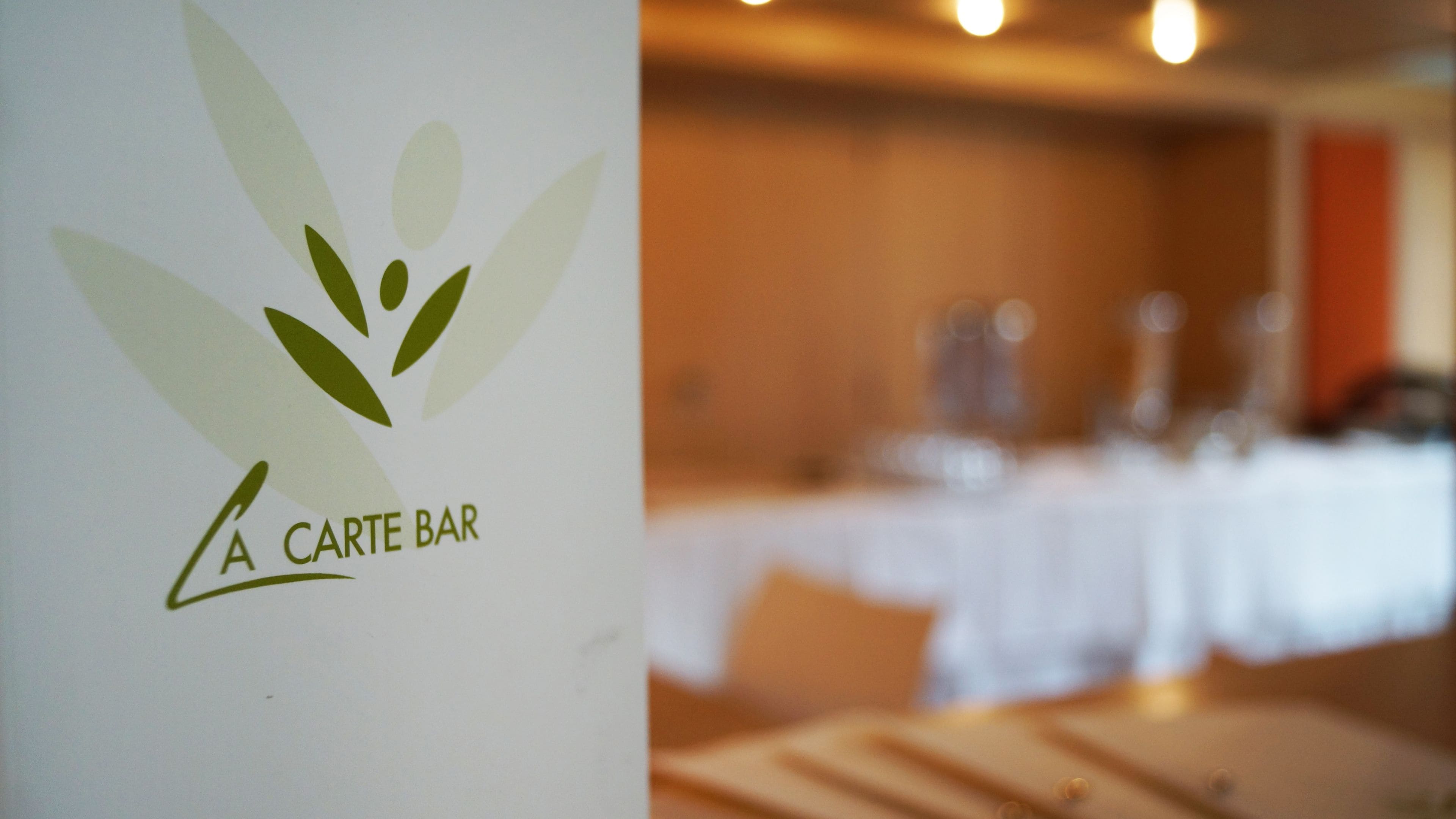 A logo with the text "A CARTE BAR" on a white background.