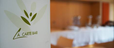 A logo with the text "A CARTE BAR" on a white background.