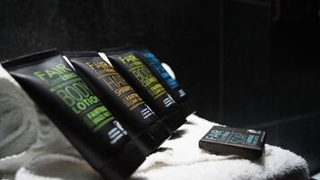 A set of toiletries including body lotion, hair shampoo, body wash, and soap.