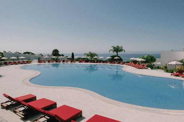 2 outdoor pools, open 10:00 AM to 8:00 PM, pool umbrellas, pool loungers