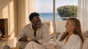 A couple sitting on a sofa with a view of the sea, a vase with dried flowers, and a book on the table. - Masana Algarve, a Destination by Hyatt (Albufeira)