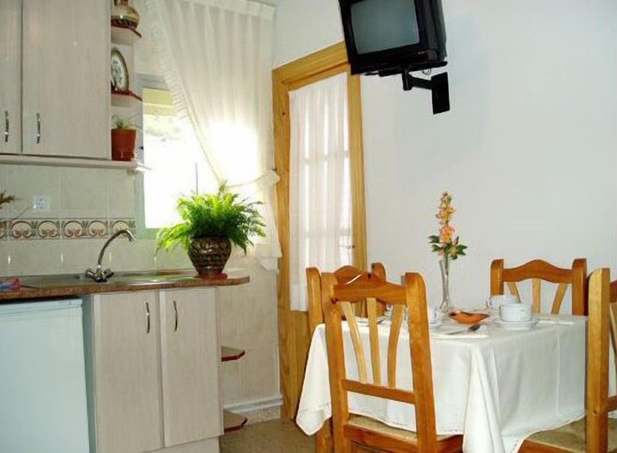 A small kitchen with a dining area.