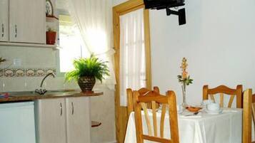 A small kitchen with a dining area.