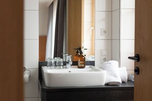 Bathroom features a sink, mirror, and bathtub.